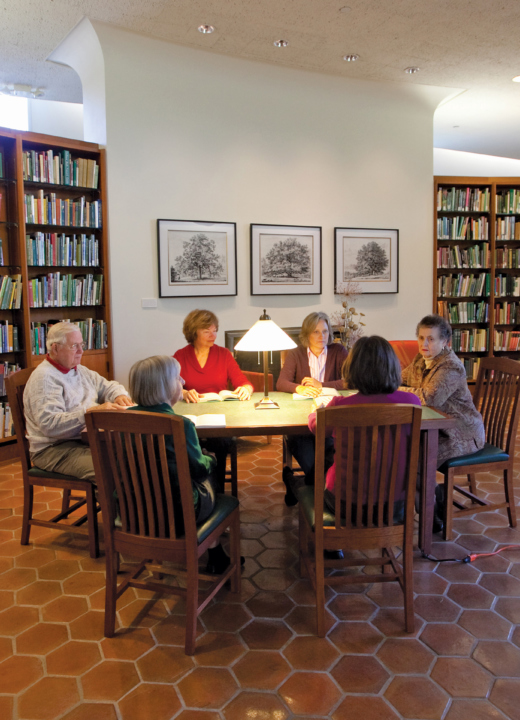 Members discuss books in the library