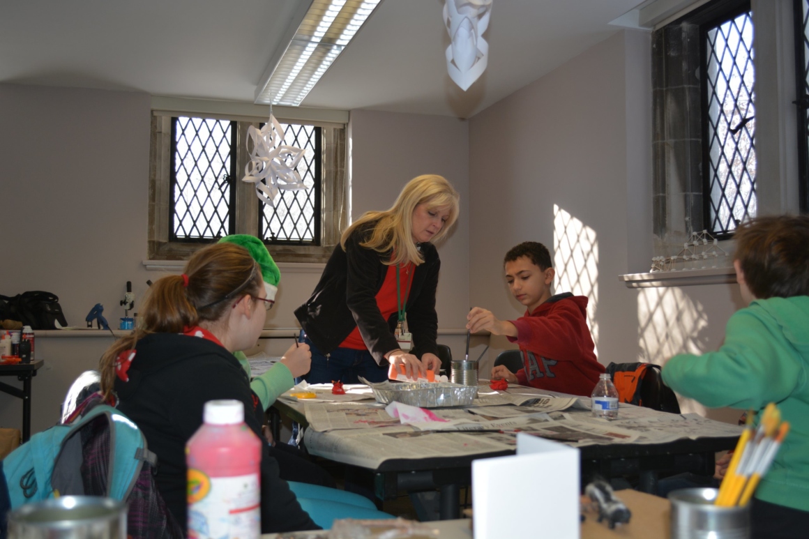 Students working at a table with teacher